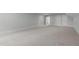Large bonus room with neutral carpet, two windows, and a recessed light fixture at 248 Ashford Dr, Pittsboro, NC 27312
