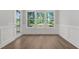Dining room with hardwood floors and large windows providing views of the backyard at 248 Ashford Dr, Pittsboro, NC 27312