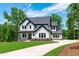 Attractive two-story house with lush lawn, a long drive, and a welcoming facade, all under a blue sky at 248 Ashford Dr, Pittsboro, NC 27312