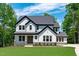 Stunning two-story home with white siding, a gray roof, manicured lawn, and beautiful curb appeal at 248 Ashford Dr, Pittsboro, NC 27312