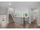 Spacious second floor hallway with a staircase and many windows for natural light at 248 Ashford Dr, Pittsboro, NC 27312
