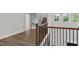 Spacious second floor hallway features hardwood floors, wrought iron railing, and staircase at 248 Ashford Dr, Pittsboro, NC 27312