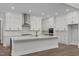 Bright kitchen featuring white cabinets, a large island, and stainless steel appliances at 248 Ashford Dr, Pittsboro, NC 27312