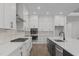 Modern kitchen with an island sink, stainless steel appliances, and wooden floors at 248 Ashford Dr, Pittsboro, NC 27312