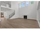 Sun-drenched living room with large windows and modern staircase to the second floor at 248 Ashford Dr, Pittsboro, NC 27312