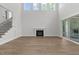 Inviting living room featuring large windows, fireplace, and stairs to the second floor at 248 Ashford Dr, Pittsboro, NC 27312