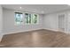 Bright living room with wood floors, recessed lights and three windows overlooking a lush outdoor view at 248 Ashford Dr, Pittsboro, NC 27312