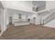 Bright living room and kitchen featuring stairs to the second floor and modern decor at 248 Ashford Dr, Pittsboro, NC 27312