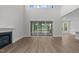 Bright living room featuring large windows, fireplace, and a view of the screened-in porch at 248 Ashford Dr, Pittsboro, NC 27312