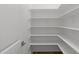 Walk in pantry with wooden floors and wrap around shelving for storage at 248 Ashford Dr, Pittsboro, NC 27312