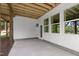 Covered patio featuring concrete flooring, white siding, and a view of the wooded backyard at 248 Ashford Dr, Pittsboro, NC 27312