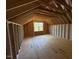 Exposed framing in the attic with a large window at 253 Inspiration Way, Fuquay Varina, NC 27526