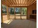Screened-in back porch with wood flooring and view of lush greenery, enhancing outdoor living space and comfort at 253 Inspiration Way, Fuquay Varina, NC 27526