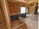 Unfinished bedroom with insulation, exposed framing, and one window in new construction home at 253 Inspiration Way, Fuquay Varina, NC 27526