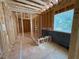 Unfinished bedroom with insulation, exposed framing, and one window in new construction home at 253 Inspiration Way, Fuquay Varina, NC 27526