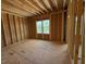Exposed wood framing with a large window providing natural light at 253 Inspiration Way, Fuquay Varina, NC 27526