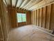 Unfinished bedroom with exposed frame and window at 253 Inspiration Way, Fuquay Varina, NC 27526