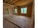 Spacious room with exposed wood framing and natural light from several windows at 253 Inspiration Way, Fuquay Varina, NC 27526