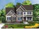 Charming new construction home with stone accents, a covered porch and a meticulously landscaped yard at 253 Inspiration Way, Fuquay Varina, NC 27526