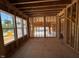 Unfinished living room with exposed framing and a view of the backyard in new construction home at 253 Inspiration Way, Fuquay Varina, NC 27526