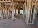 Unfinished living room with exposed framing and staircase in new construction home at 253 Inspiration Way, Fuquay Varina, NC 27526
