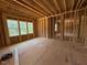 Spacious room showcasing exposed wood framing with natural light from three windows at 253 Inspiration Way, Fuquay Varina, NC 27526