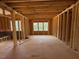 Open-concept room featuring exposed wood framing with natural light from three windows at 253 Inspiration Way, Fuquay Varina, NC 27526