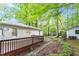 Outdoor view of house featuring a wooden deck and spacious backyard with trees at 2612 Wade Hampton Rd, Hillsborough, NC 27278