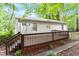 Exterior view of home with a large wooden deck, siding, and lush greenery at 2612 Wade Hampton Rd, Hillsborough, NC 27278