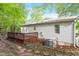 View of house exterior featuring a wooden deck, yard, and AC unit at 2612 Wade Hampton Rd, Hillsborough, NC 27278