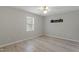 Bright bedroom with light gray walls, wood-look flooring, and a ceiling fan at 2612 Wade Hampton Rd, Hillsborough, NC 27278