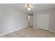 Bright bedroom with light gray walls, wood-look flooring, and a double door closet at 2612 Wade Hampton Rd, Hillsborough, NC 27278