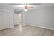 Bedroom featuring light gray walls, wood-look flooring, and a connecting bathroom at 2612 Wade Hampton Rd, Hillsborough, NC 27278