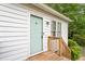 Close up of the front entrance door to the house, with a wooden deck at 2612 Wade Hampton Rd, Hillsborough, NC 27278
