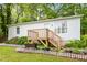 Single-story home featuring a wooden deck with a cute flower box and garden at 2612 Wade Hampton Rd, Hillsborough, NC 27278