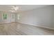 Spacious living room with natural light, new gray vinyl floors, and ceiling fan at 2612 Wade Hampton Rd, Hillsborough, NC 27278