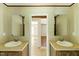 Dual sinks with matching mirrors, providing a symmetrical and functional design, creating a well-equipped bathroom space at 2832 Ladale Ln, Mebane, NC 27302