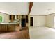 Bright open kitchen and living room with stainless steel appliances, wood cabinets, and hardwood floors throughout at 2832 Ladale Ln, Mebane, NC 27302