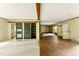 Open-concept living room boasts wood-look floors and exposed beams, offering a spacious and inviting atmosphere at 2832 Ladale Ln, Mebane, NC 27302