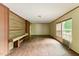 Bright living room with hardwood floors, decorative wood paneling, and a large window showcasing natural light at 2832 Ladale Ln, Mebane, NC 27302