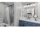 Charming bathroom features shower, toilet and vanity with blue cabinets at 3 Haggis Ct, Durham, NC 27705