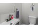 Neat half bathroom features sleek black faucet, white sink, and toilet with a modern aesthetic at 3 Haggis Ct, Durham, NC 27705