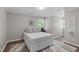 Comfortable bedroom with plush bedding, neutral colors, and wood flooring providing a serene atmosphere at 3 Haggis Ct, Durham, NC 27705