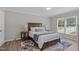 Cozy bedroom features wood floors, neutral walls, and a large window at 3 Haggis Ct, Durham, NC 27705