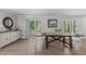 Spacious dining area with a modern table, sleek cabinets, and sliding doors leading to an outdoor deck at 3 Haggis Ct, Durham, NC 27705