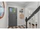 Inviting foyer with a stylish door, black and white checkered floor mat, and staircase leading to the upper level at 3 Haggis Ct, Durham, NC 27705