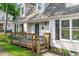 Close-up of the inviting front porch with wooden railings and charming details, leading to the home's entrance at 3 Haggis Ct, Durham, NC 27705