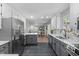 Open kitchen with gray lower cabinets, breakfast bar, and stainless steel refrigerator at 3 Haggis Ct, Durham, NC 27705