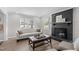 Cozy living room with a sofa, fireplace, and windows providing natural light creating a warm ambiance at 3 Haggis Ct, Durham, NC 27705