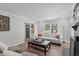 Bright living room featuring a comfortable sofa, fireplace, and ample natural light from the windows at 3 Haggis Ct, Durham, NC 27705